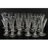 Nineteen 19th century drinking glasses with fluted bowls and cut decoration, knopped stems, on round