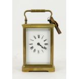 French brass carriage clock, white enamel dial with Roman numerals, corniche case, striking on a