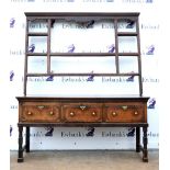 18th century and later oak dresser, the associated plate rack with a carved cherubs face, above