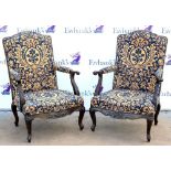 Pair of 20th century mahogany armchairs in Victorian style with floral upholstery on cabriole legs.