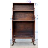 19th century mahogany waterfall bookcase on turned legs and castors. 102H x 54W x 28D