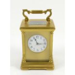 Gilt brass gorge cased carriage clock, the white enamel dial with Arabic numerals and outer minute