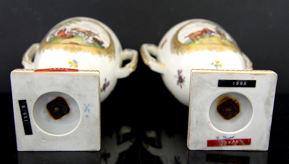 A pair of two handled Continental porcelain urns and covers with central cartouches painted with - Image 5 of 5