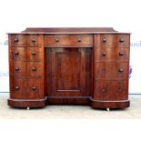 Late 19th century bowed breakfront mahogany writing desk with central single drawer flanked four