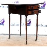 Early 19th century mahogany sewing table with two drawers (and two dummy) on turned legs on castors.