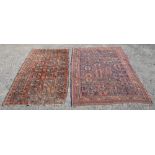 Persian blue ground rug with repeating stylised floral motifs within stylised floral borders, 228
