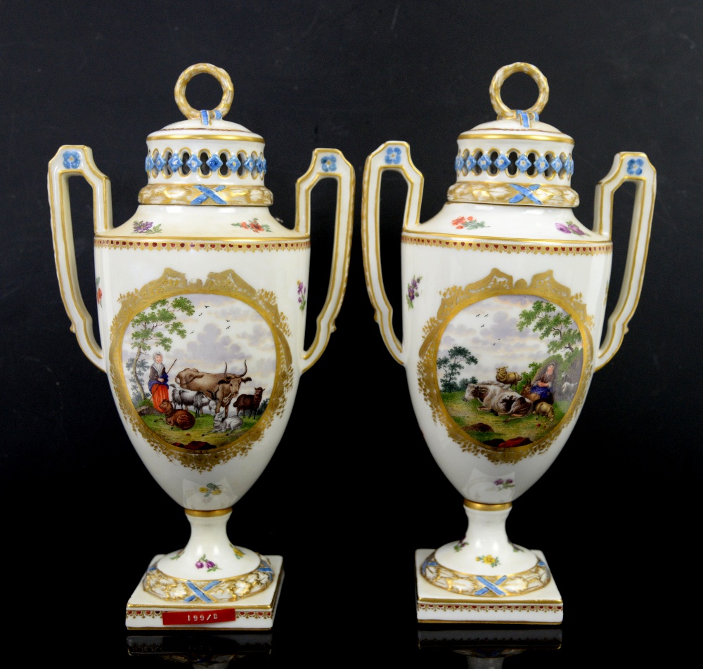 A pair of two handled Continental porcelain urns and covers with central cartouches painted with - Image 2 of 5