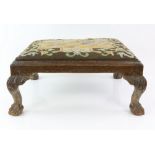 19th century carved mahogany framed foot stool, the drop with a wool work tapestry top depicting