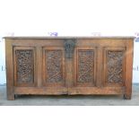 Late 19th century oak panelled coffer, the front carved with panels of acorns. 140W x 70H x 62D (cm)