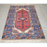 AMENDED DESCRIPTION Turkish rug with diamond medallion and floral branches on red ground contained