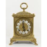 Early 20th century brass mantel clock with white enamelled cartouches and Roman numerals, on