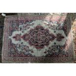 Antique Persian rug with repeating floral design on a blue ground within stylised floral border, 196