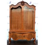 20th century walnut glazed display cabinet with carved scrolled cornice above two shaped bevelled