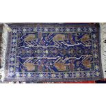 Persian rug with lion, bird and geometric motifs on a blue ground within stylised floral border