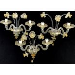 Three Murano glass two branch wall sconces, with flowering stems with gilt detailing, H34 x W39cm (