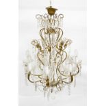 Gilt metal eight light chandelier with three tiers of drops and beads, scrolling arms, glass drops