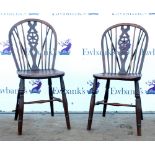 Pair of 18th century yew wood wheelback Windsor dining chairs on turned legs united by a stretcher.