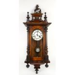 Mahogany Vienna style wall clock, the white enamel chapter ring with Roman numerals, the mahogany