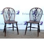 Pair of 19th century scullery wheelback Windsor chairs on turned legs united by stretchers