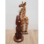 CARVED TRIBAL BUST TABLE LAMP BASE TOGETHER WITH PAINTED AND CARVED GIRAFFES