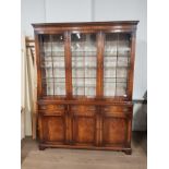 BEVAN FUNNELL FLAMED MAHOGANY TRIPLE DOOR WALL UNIT WITH GLAZED DOORS AND 3 TIERS OF SHELVING