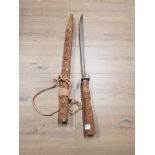 HEAVILY CARVED WOODEN HANDLED ORNAMENTAL SWORD AND SHEATH