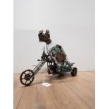 A WINE BOTTLE HOLDER IN THE SHAPE OF A MOTORBIKE RIDER