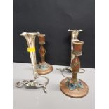 A PAIR OF EPNS TRUMPET POSY VASES WITH A PAIR OF WOODEN FOLK ART CANDLESTICKS