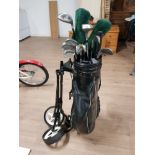 A GOLF BAG CONTAINING CLUBS TOGETHER WITH A GOLF TROLLEY