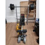A WEIGHT BENCH WITH ASSORTED WEIGHTS