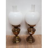 PAIR OF BRASS OIL LAMPS WITH GLASS CHIMNEYS AND WHITE GLOBE SHADES HEIGHT 50CM