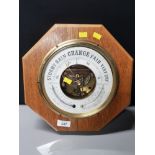 HANGING BRASS BOUND ANEROID BAROMETER ON OCTAGONAL SHAPED OAK BACKGROUND HEIGHT 32CM