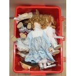 A BOX CONTAINING ASSORTED PORCELAIN HEADED DOLLS