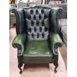 GREEN LEATHER AND STUDDED BUTTONED AND WING BACK CHESTERFIELD ARMCHAIR