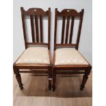 A PAIR OF OAK DINING CHAIRS WITH UPHOLSTERED SEATS