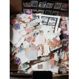 BOX CONTAINING OVER 1000 LOOSE STAMPS FROM AROUND THE WORLD