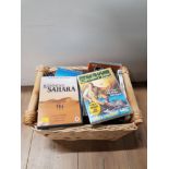 A WICKER BASKET CONTAINING ASSORTED DVDS