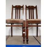 A PAIR OF OAK DINING CHAIRS WITH UPHOLSTERED SEATS