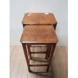 A NEST OF 2 VINTAGE OAK TABLES