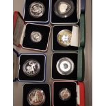 BOX CONTAINING 8 SILVER PROOF COINS FROM AROUND THE WORLD ALL IN ORIGINAL CASES