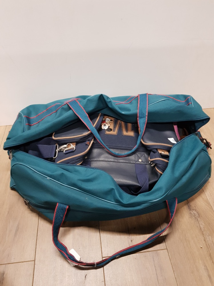 A HOLDALL CONTAINING OTHER BAGS