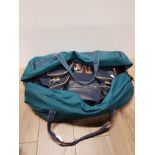 A HOLDALL CONTAINING OTHER BAGS