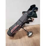 A GOLF TROLLEY WITH BAG AND CLUBS