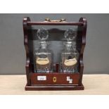 MAHOGANY TWO BOTTLE TANTALUS COMES WITH PAIR OF HAND CUT CRYSTAL WHISKY DECANTERS BY STERLING