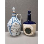 BUCHAN STONEWARE WHISKEY FLAGON TOGETHER WITH A WILLIAM WHITELEY FLAGON