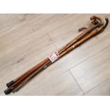 BUNDLE OF MISCELLANEOUS WALKING STICKS AND ORNAMENTAL PAINTED WOODEN AXE