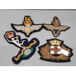 FOUR CLOTH BADGES OF WHICH 3 ARE MILITARY RELATED