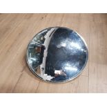 A CIRCULAR SHOP MIRROR