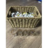 A WICKER BASKET CONTAINING A LARGE AMOUNT OF THIMBLES AND MATCHES