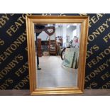 A GILT FRAMED BEVELLED EDGED MIRROR